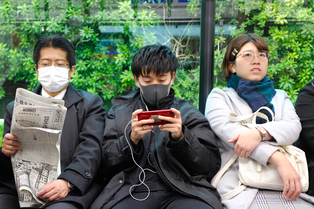 Three_Japanese_people_on_train Japanese people on a train