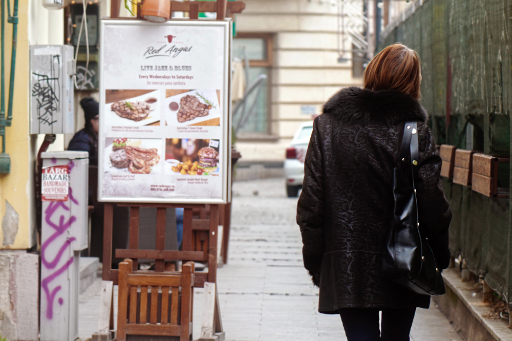 Woman_walking_towards_advert woman walking towards street ad